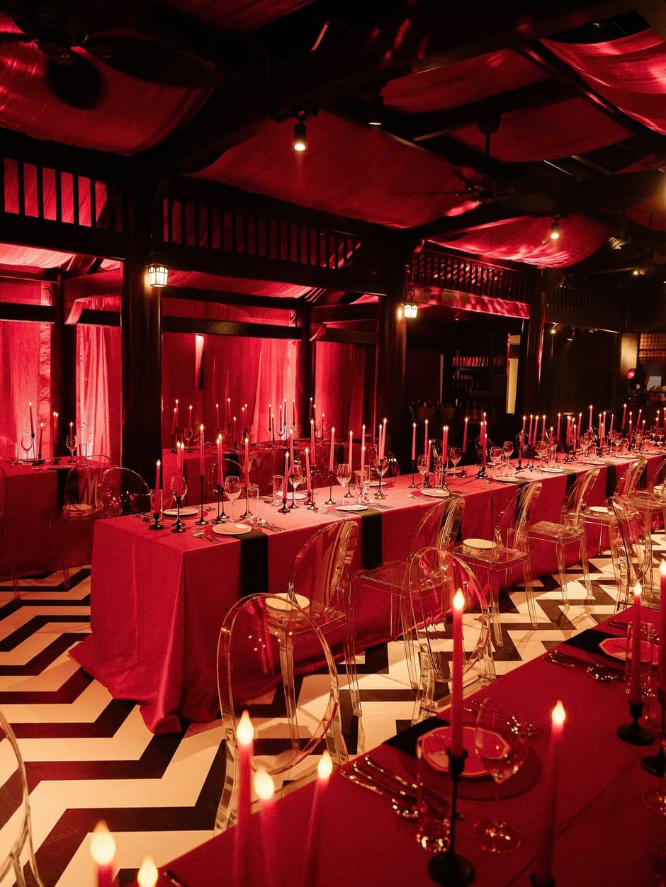 Candlelit red wedding reception table setting