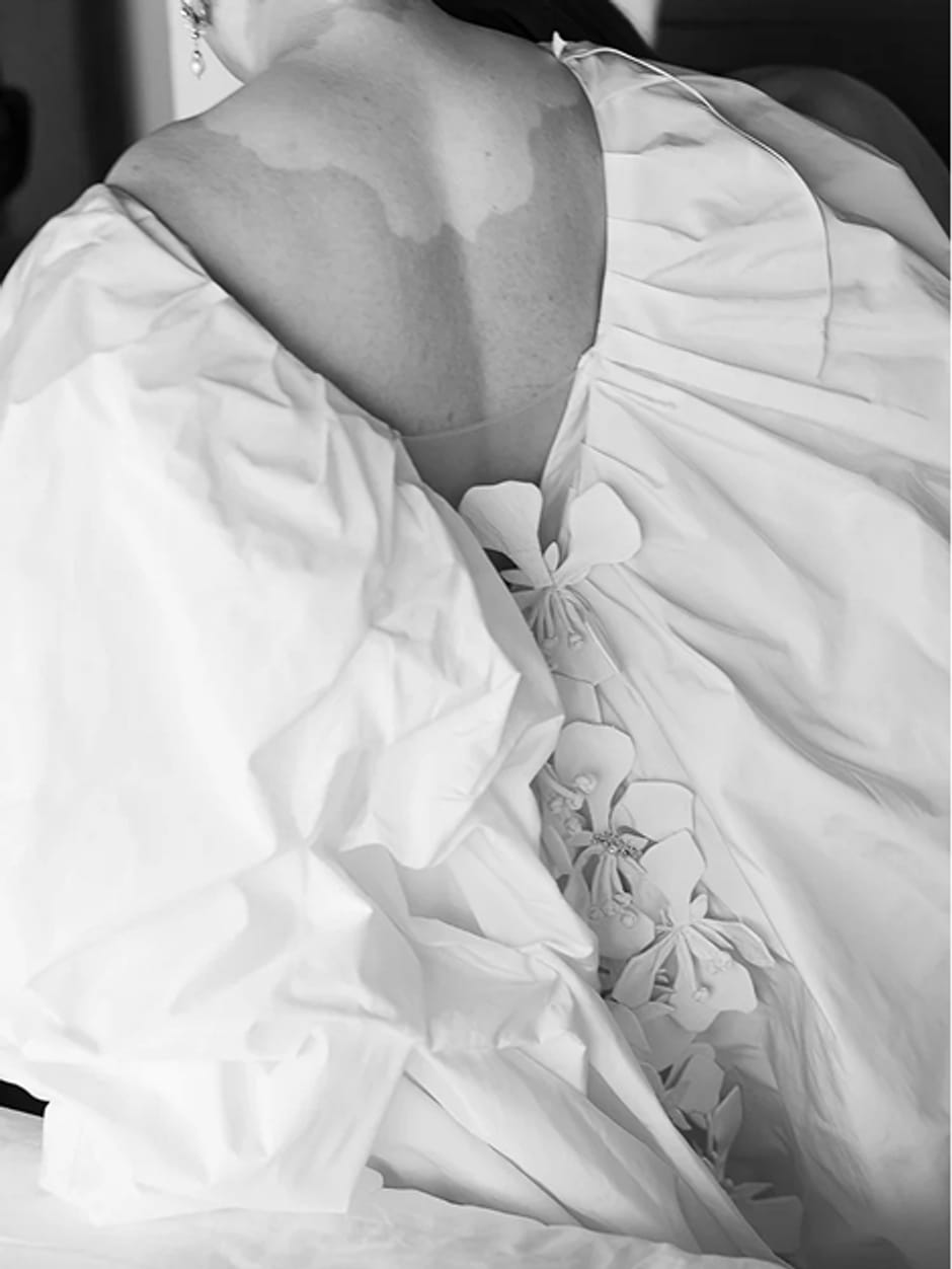 Black and white close-up of a bride's gown detail