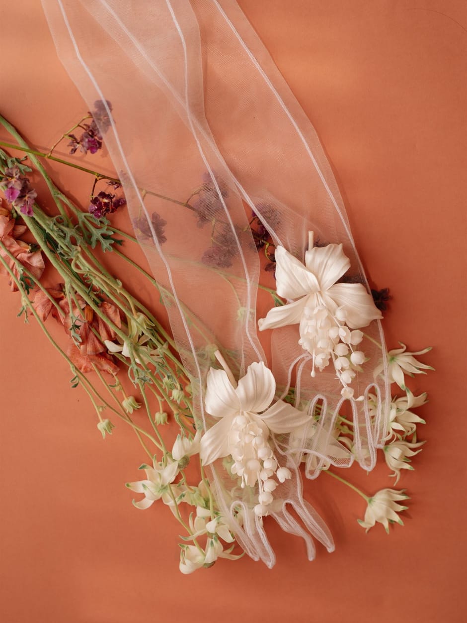 Dried florals and tulle ribbon detail on a terracotta background
